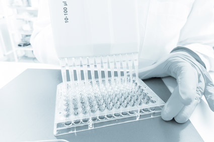 Scientist pipetting a plate